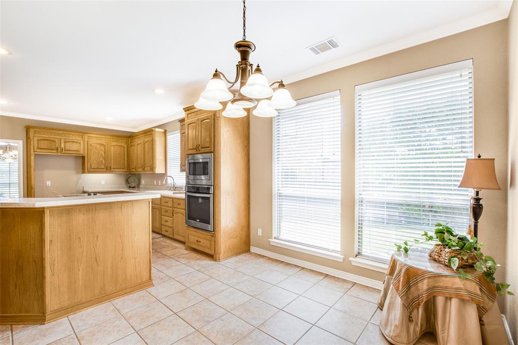 850 Turquoise Point Rockwall, TX 75032 - Photo 18 of 40 a kitchen with stainless steel appliances granite countertop a refrigerator a sink a stove and a window