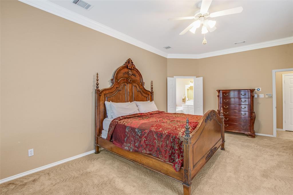 850 Turquoise Point Rockwall, TX 75032 - Photo 23 of 40 a bed sitting in a bedroom next to a window and a chandelier