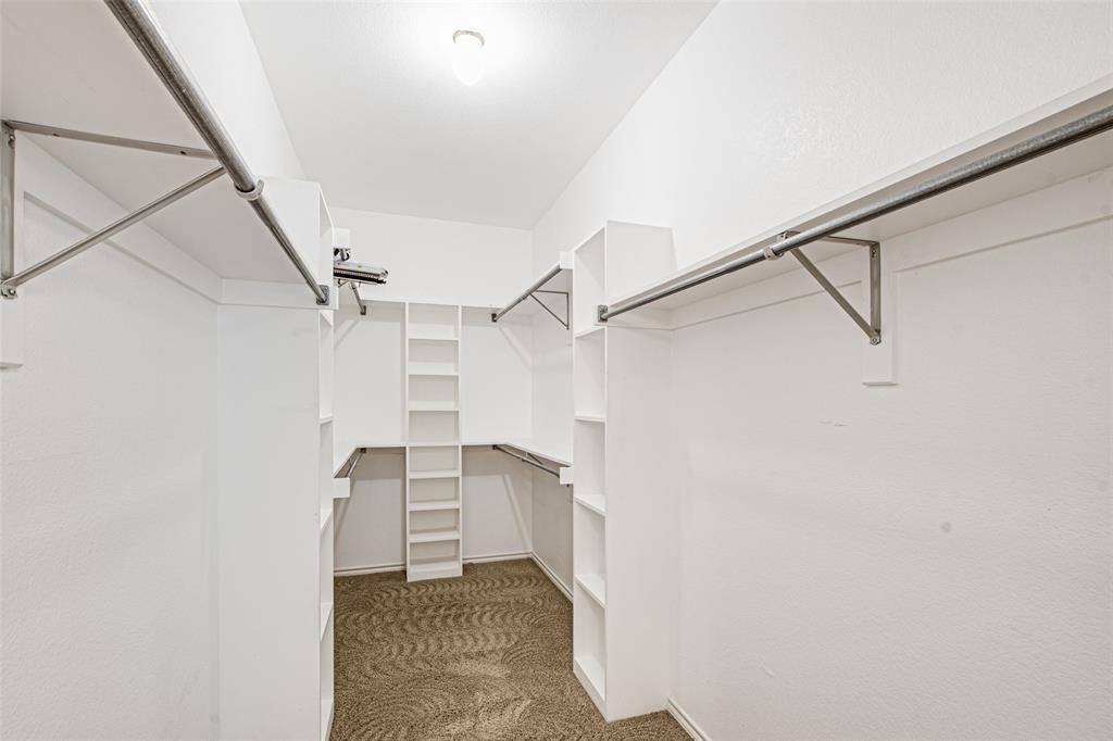 850 Turquoise Point Rockwall, TX 75032 - Photo 26 of 40 a view of walk in closet with empty racks