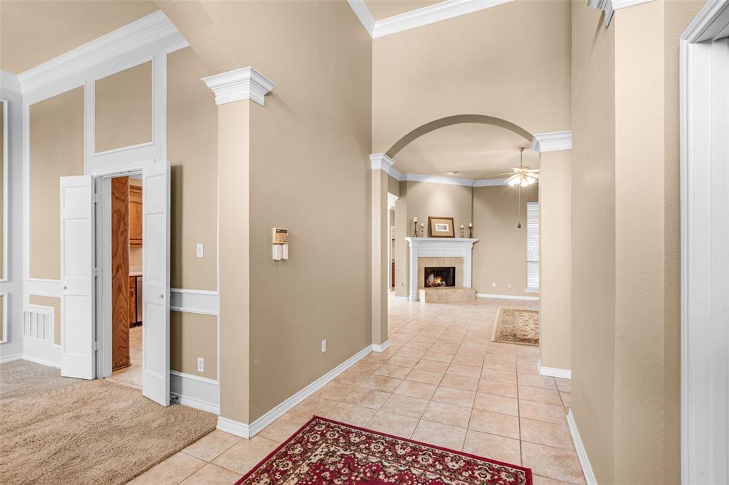 850 Turquoise Point Rockwall, TX 75032 - Photo 3 of 40 a view of a hallway with wooden floor and a living room