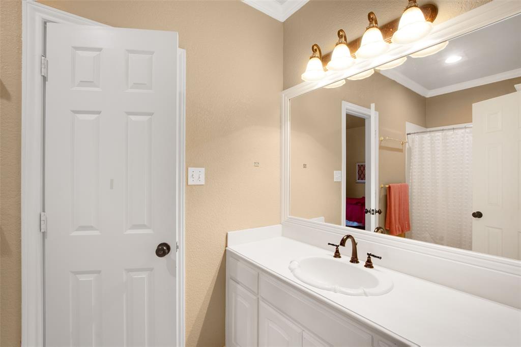 850 Turquoise Point Rockwall, TX 75032 - Photo 32 of 40 a bathroom with a sink vanity and a mirror