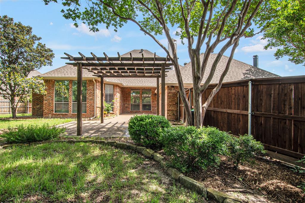 850 Turquoise Point Rockwall, TX 75032 - Photo 37 of 40 a view of a house with a large tree and a yard in front of it