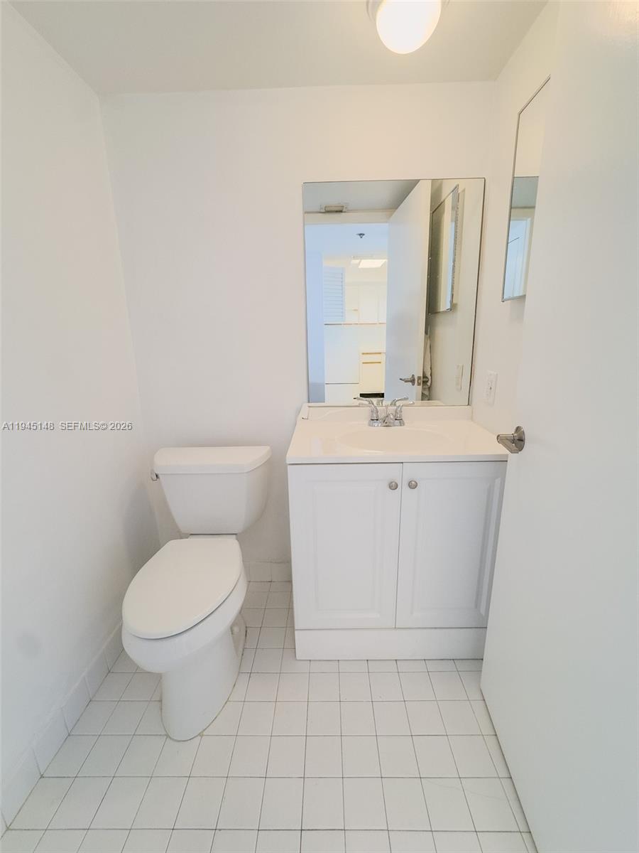 540 Brickell Key Drive, Unit 1201 Miami, FL 33131 - Photo 11 of 18 a spacious bathroom with a toilet a sink and a mirror