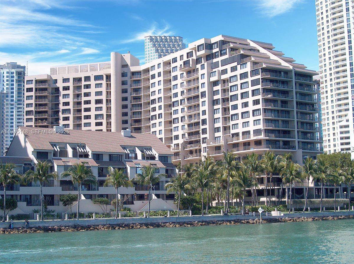 540 Brickell Key Drive, Unit 1201 Miami, FL 33131 - Photo 2 of 18 a large building with a large window and palm trees