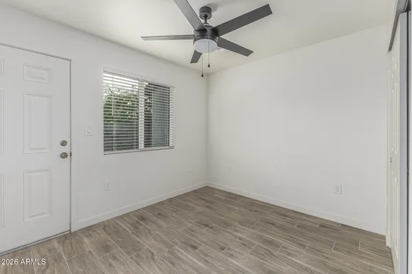 wooden floor in an empty room with a window