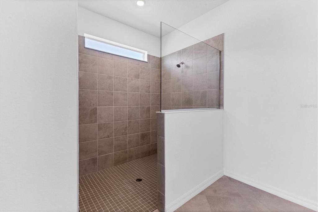 19095 Cabernet Court Venice, FL 34293 - Photo 17 of 76 a bathroom with a shower and a sink