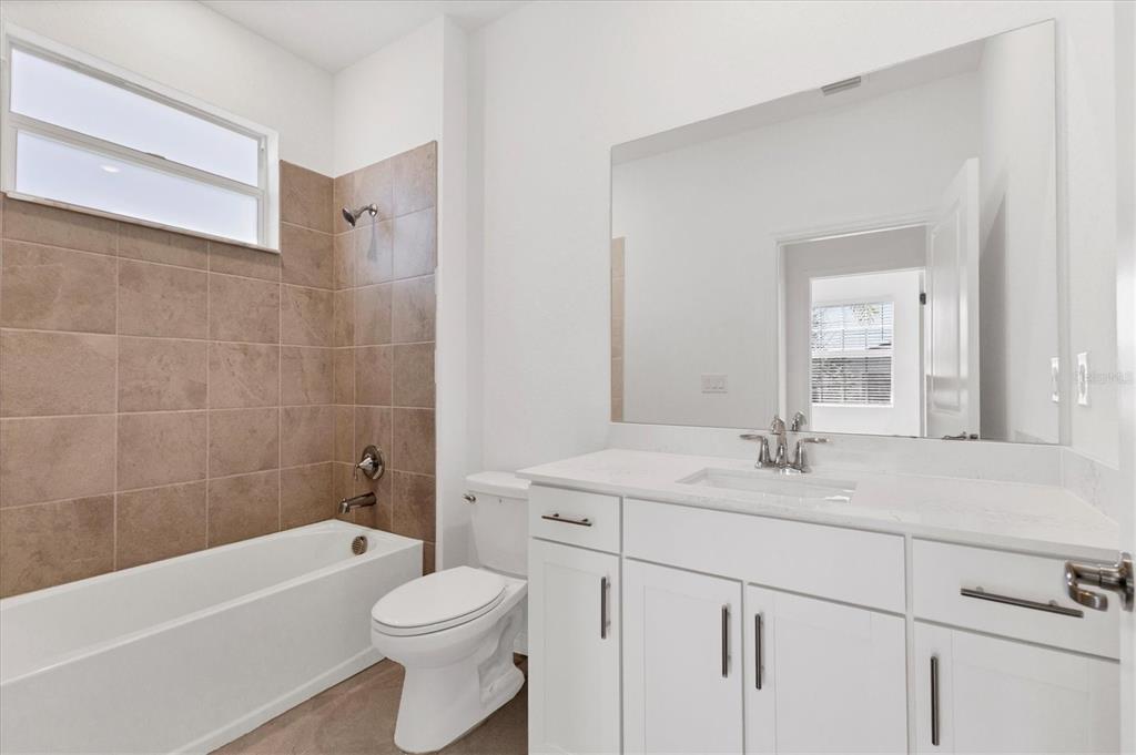 19095 Cabernet Court Venice, FL 34293 - Photo 20 of 76 a bathroom with a sink a toilet and a bathtub