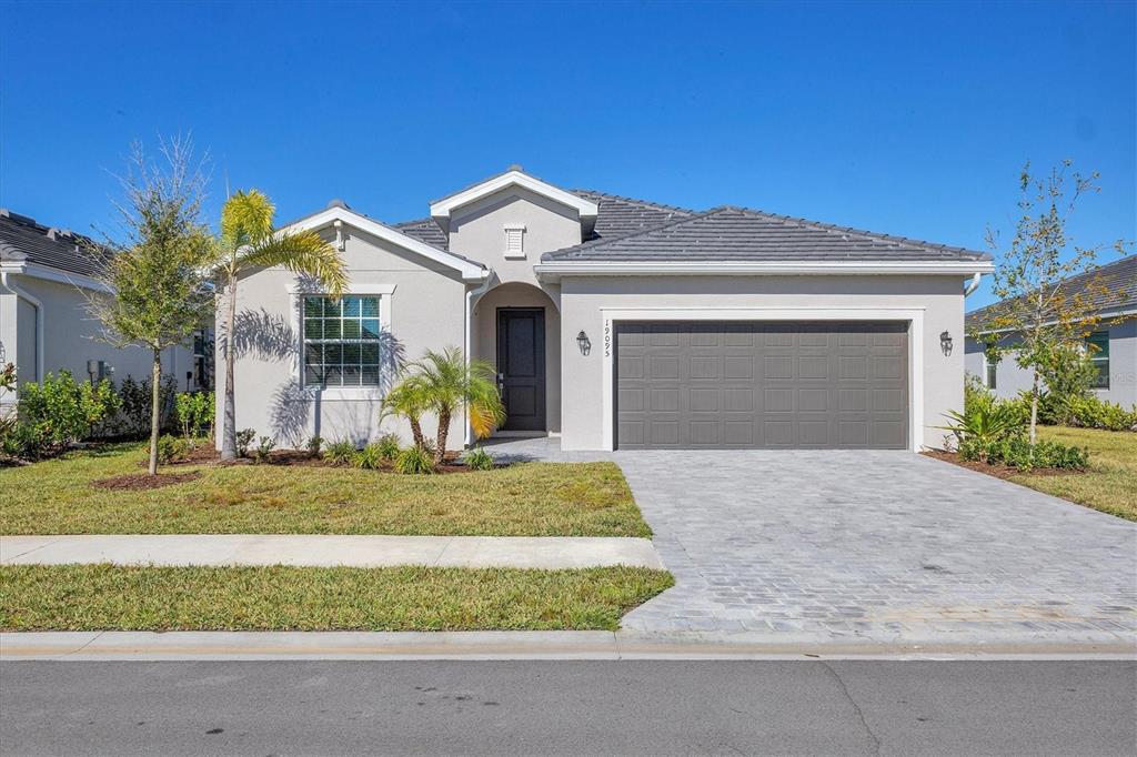 19095 Cabernet Court Venice, FL 34293 - Photo 2 of 76 a front view of a house with a yard and garage