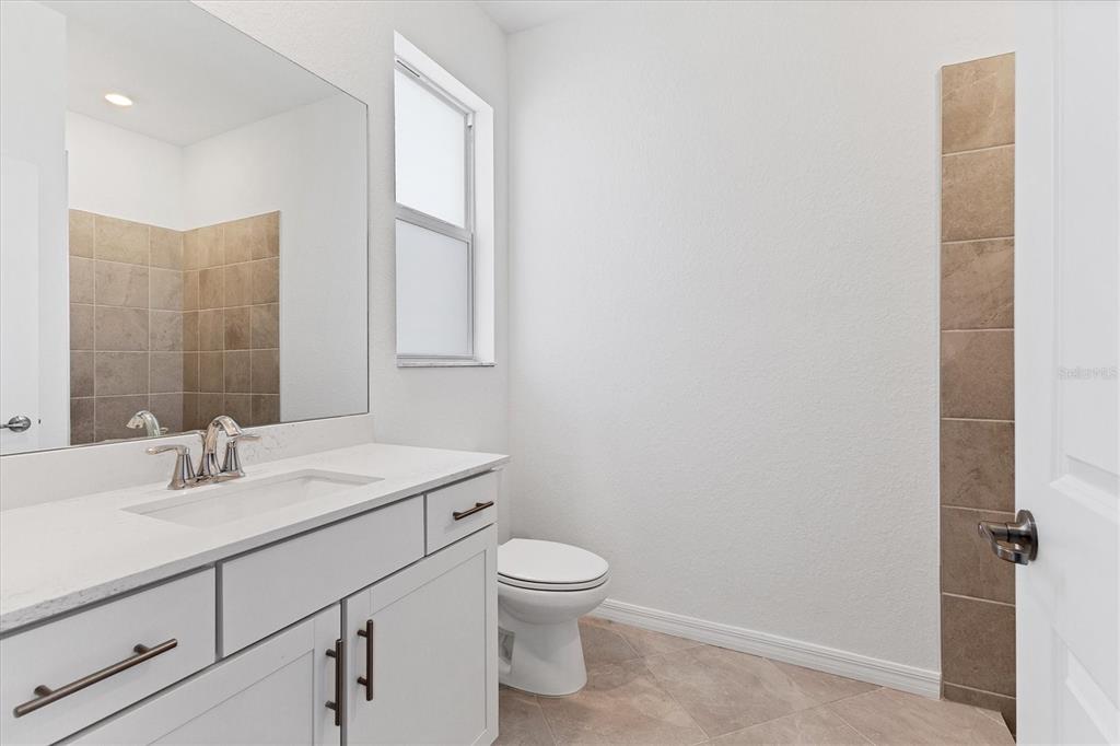19095 Cabernet Court Venice, FL 34293 - Photo 22 of 76 a bathroom with a sink toilet and vanity