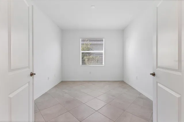 a view of a city with lawn chairs and a large pool with lawn chairs