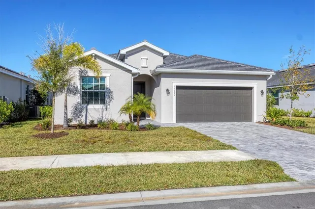 a front view of a house with a yard and garage