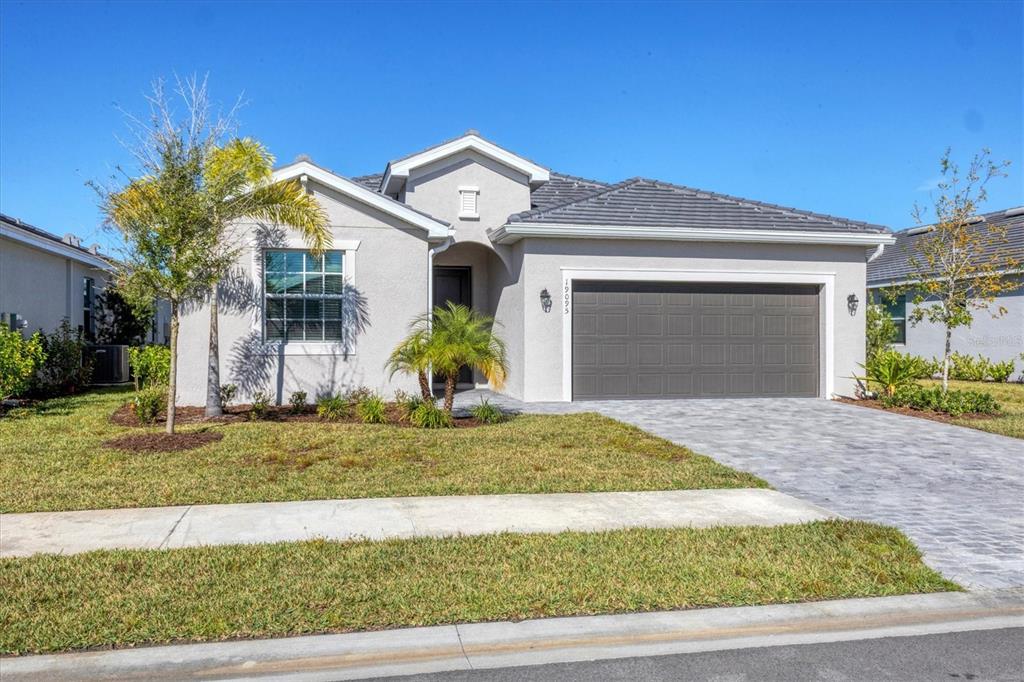 19095 Cabernet Court Venice, FL 34293 - Photo 3 of 76 a front view of a house with a yard and garage