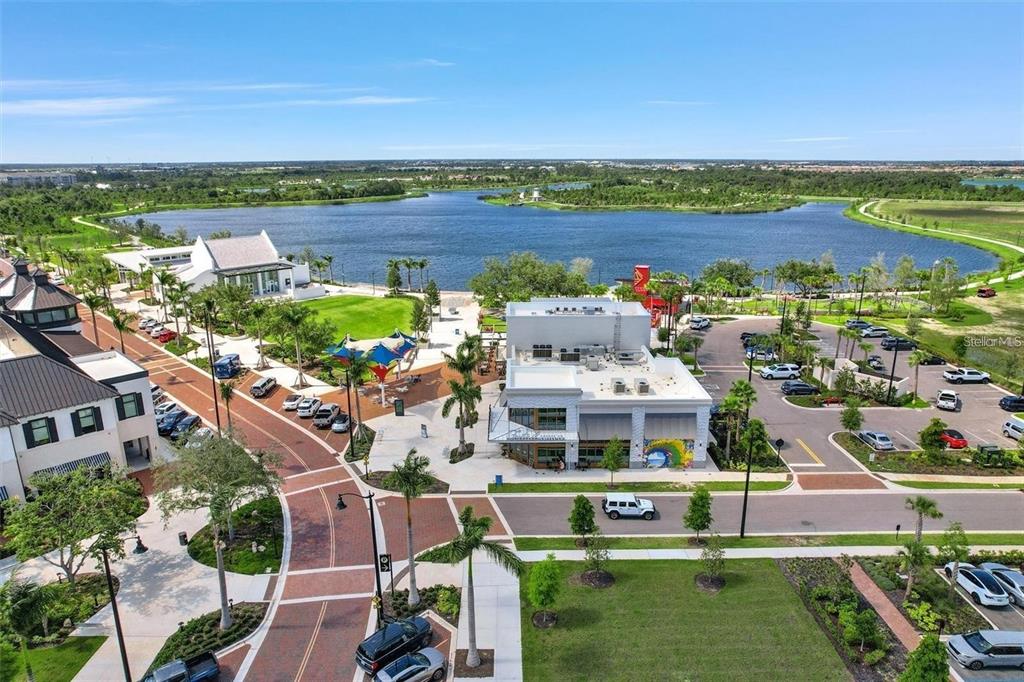 19095 Cabernet Court Venice, FL 34293 - Photo 38 of 76 a view of a city with lawn chairs and a large pool with lawn chairs