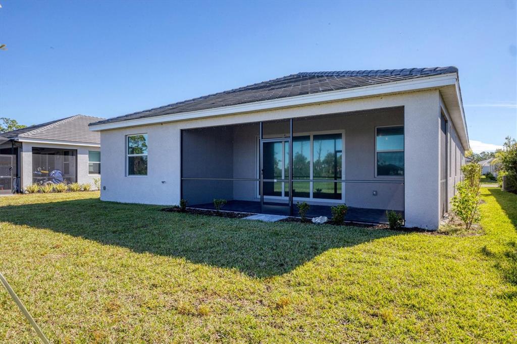 19095 Cabernet Court Venice, FL 34293 - Photo 44 of 76 a view of a house with a yard and plants