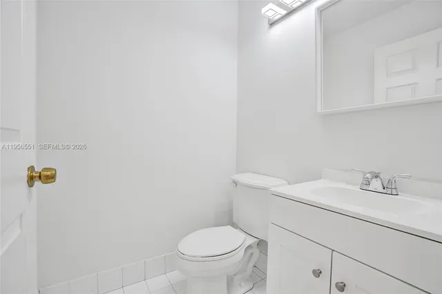 a bathroom with a sink toilet and a mirror