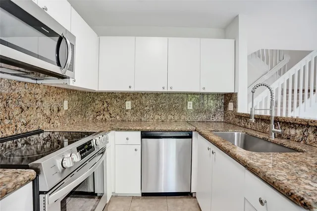 a kitchen that has a sink and a stove