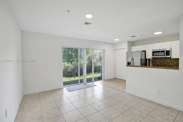a view of a kitchen with furniture and natural light