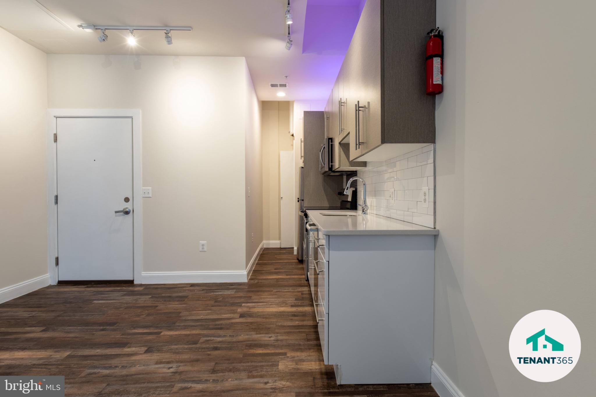8 East Fayette Street, Unit 201 Baltimore, MD 21202 - Photo 4 of 14 Modern kitchen with sleek finishes.
