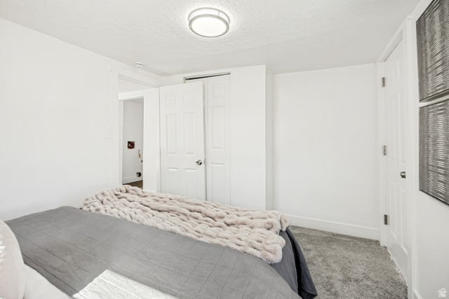 712 9th Street Ogden, UT 84404 - Photo 6 of 15 Bright bedroom with plush gray carpeting and white painted walls