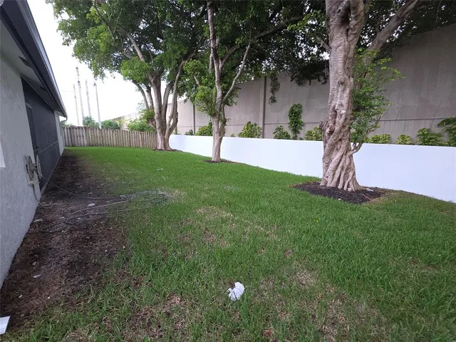 a view of a yard with a tree