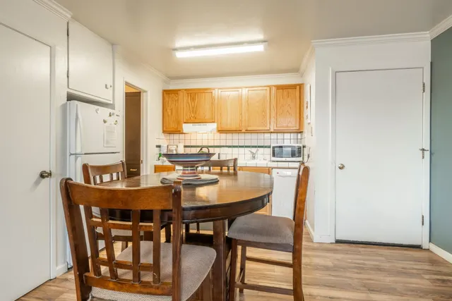 a dining room with furniture and wooden floor