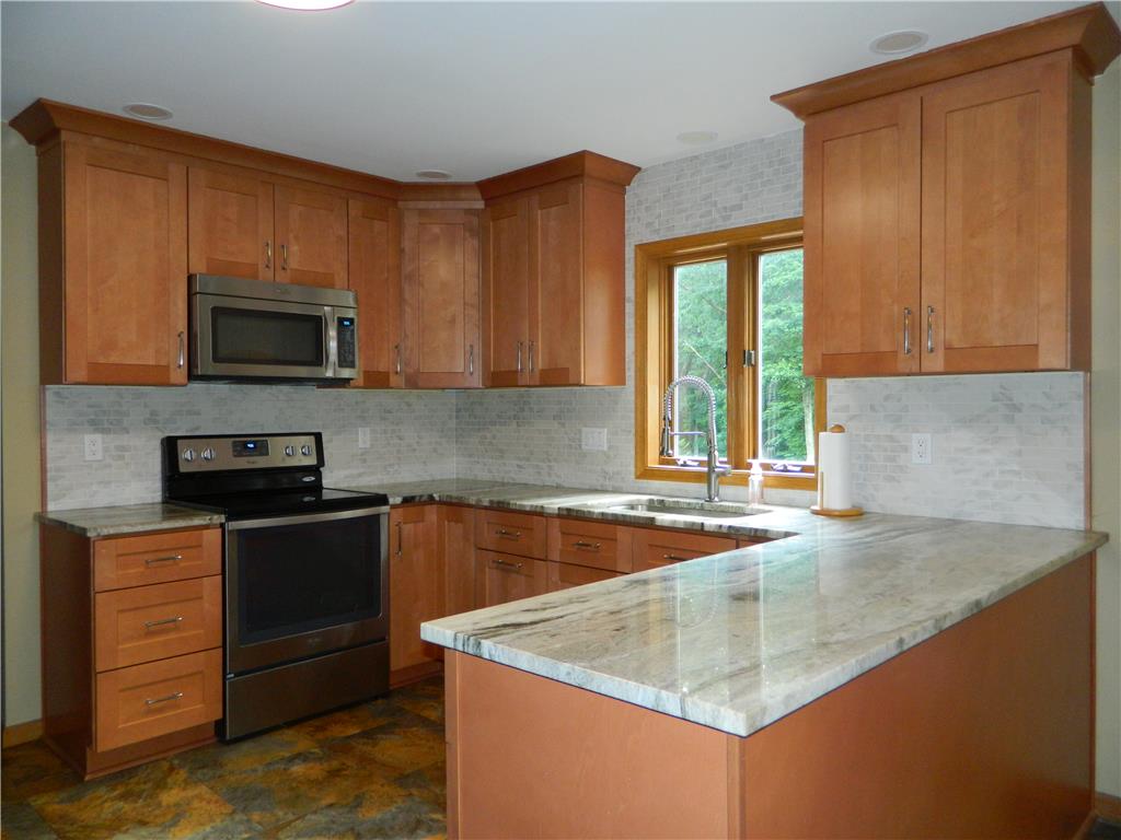 328 Pin Oak Road Stroudsburg, PA 18360 - Photo 21 of 42 A well-appointed kitchen features rich wooden cabinetry, gleaming granite countertops, and modern stainless steel appliances.