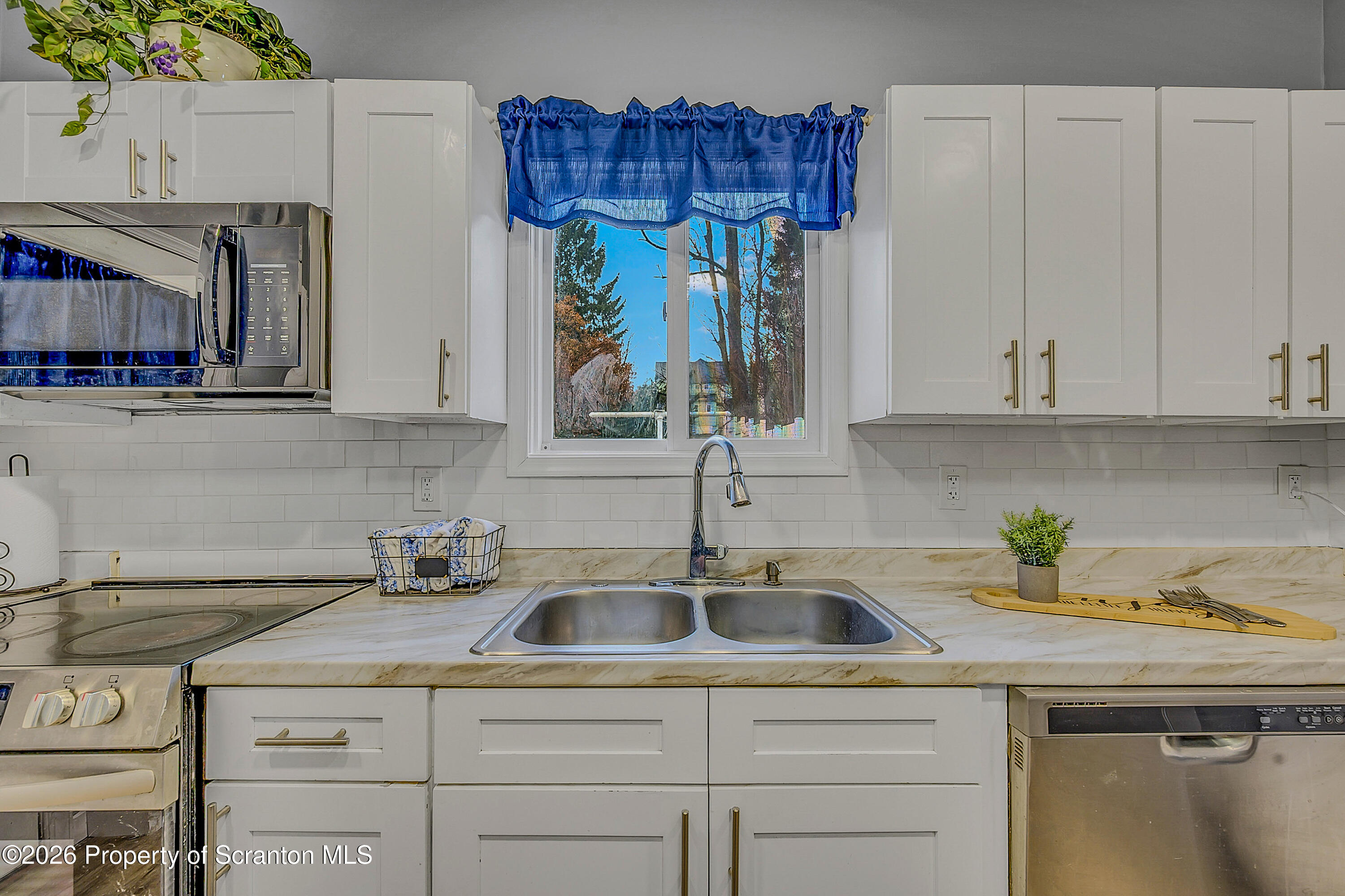 215 North Fillmore Avenue Scranton, PA 18504 - Photo 10 of 25 a kitchen with stainless steel appliances granite countertop a sink and a white cabinets
