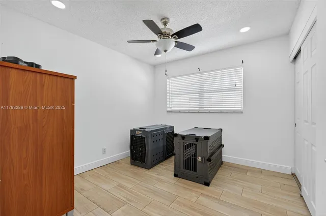 a bedroom with a bed and a ceiling fan