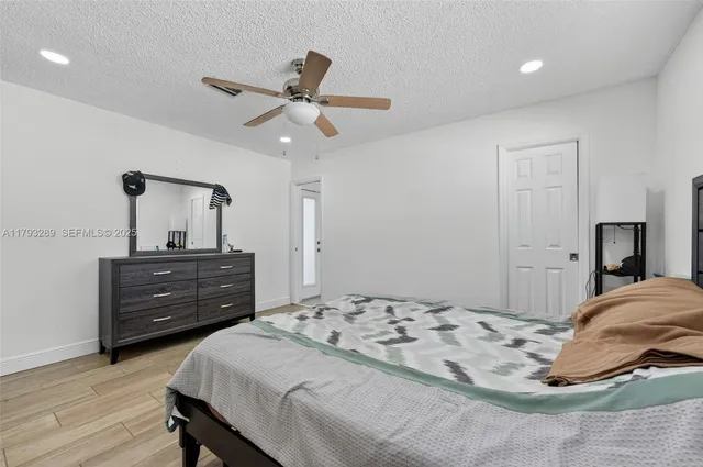 a kitchen with stainless steel appliances granite countertop a refrigerator a stove top oven a sink and a center island