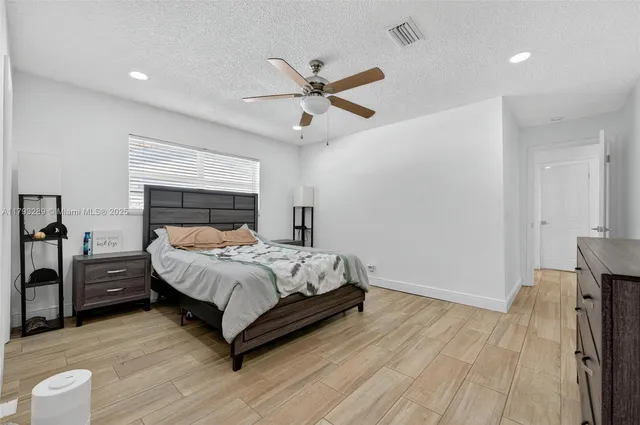 a kitchen with stainless steel appliances granite countertop a refrigerator a stove top oven a sink and a center island