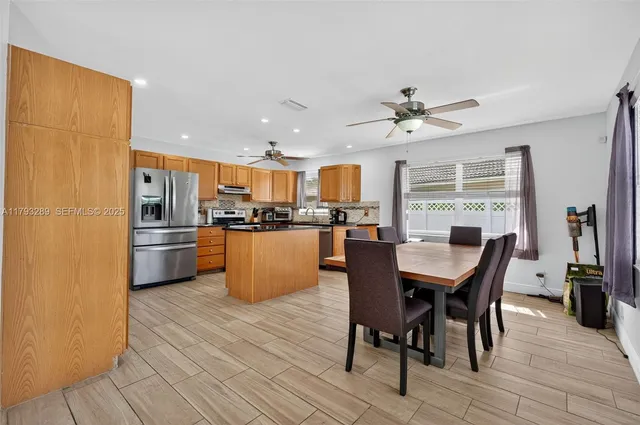 a view of a backyard with a garden and entertaining space