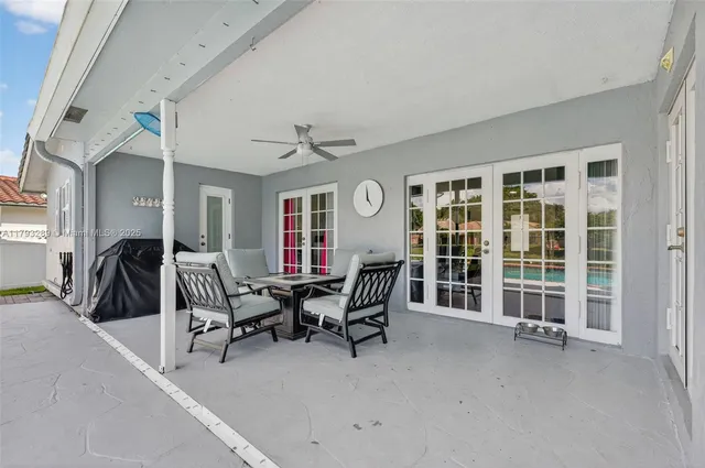 a view of backyard with swimming pool and seating space