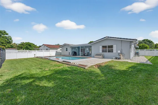 an aerial view of multiple houses with a yard