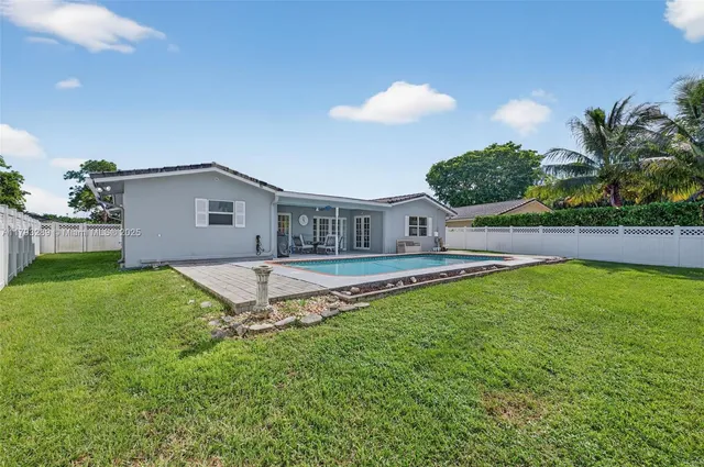 an aerial view of residential houses with outdoor space and street view