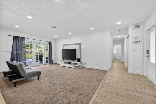 a view of a livingroom with a flat screen tv and a large window