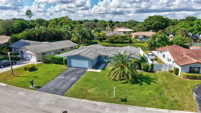 a aerial view of a house with swimming pool and big yard
