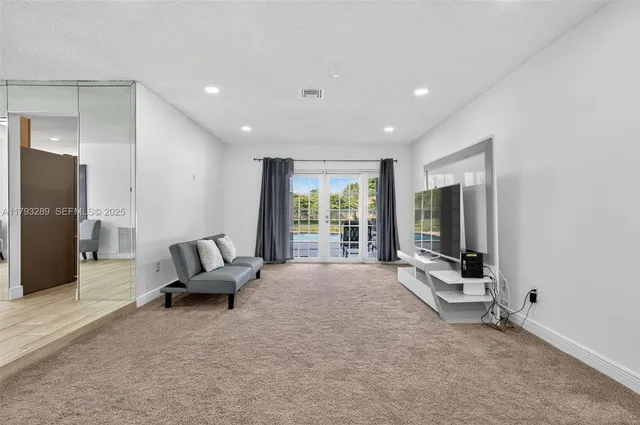 a living room with furniture large window and flat screen tv