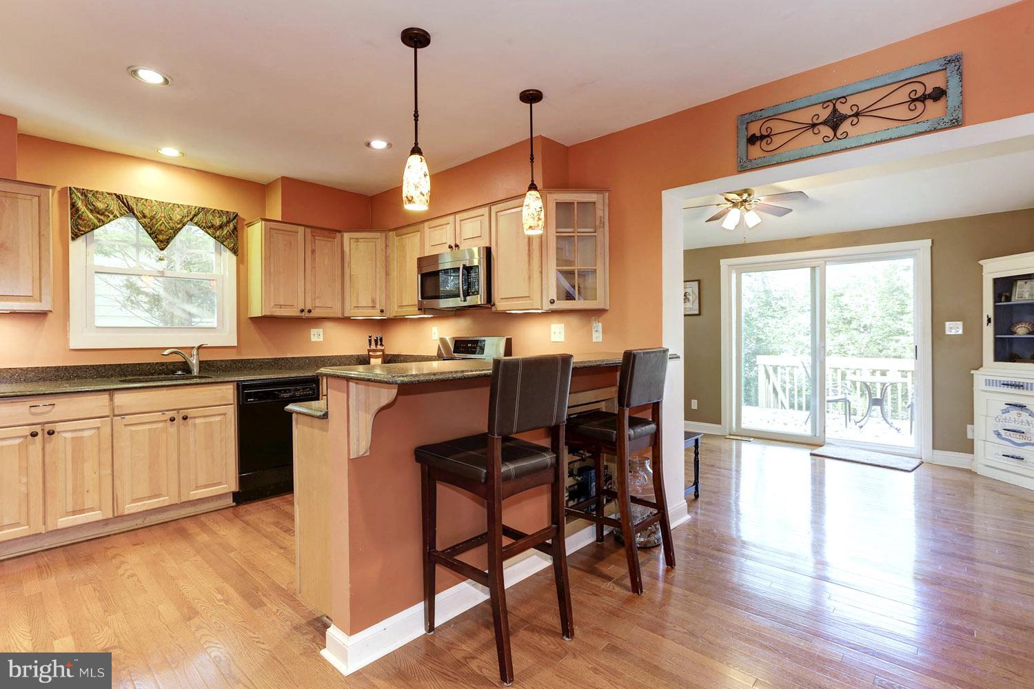 307 Gibson Road Annapolis, MD 21401 - Photo 13 of 31 Kitchen Spilling into Sun-Dappled Dining Area