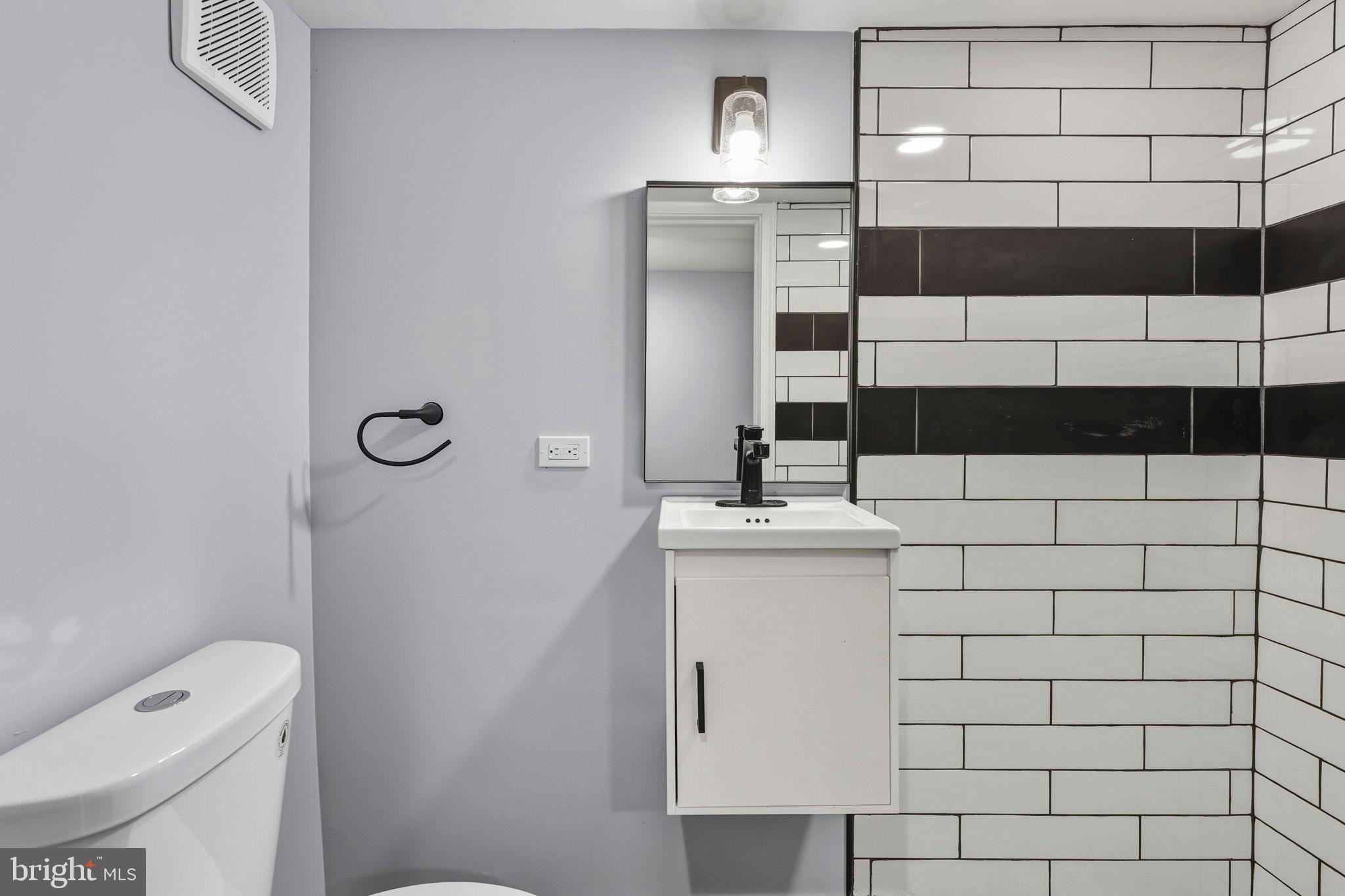 1618 North Regester Street Baltimore, MD 21213 - Photo 18 of 29 a bathroom with a sink a toilet and shower