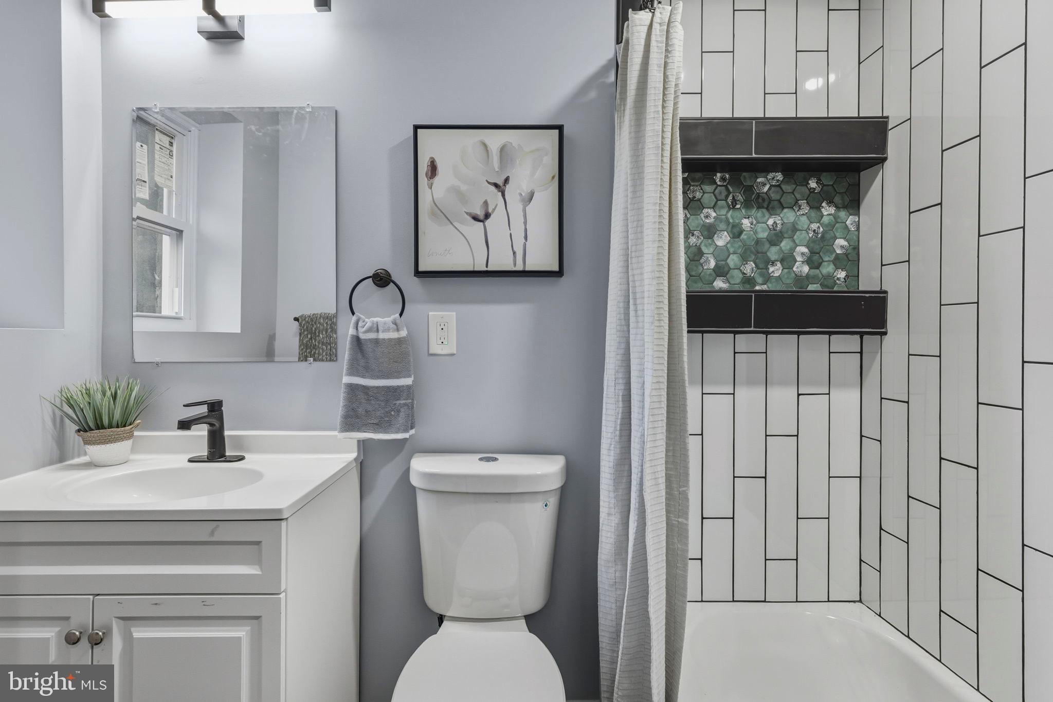 1618 North Regester Street Baltimore, MD 21213 - Photo 20 of 29 a bathroom with a toilet sink and mirror