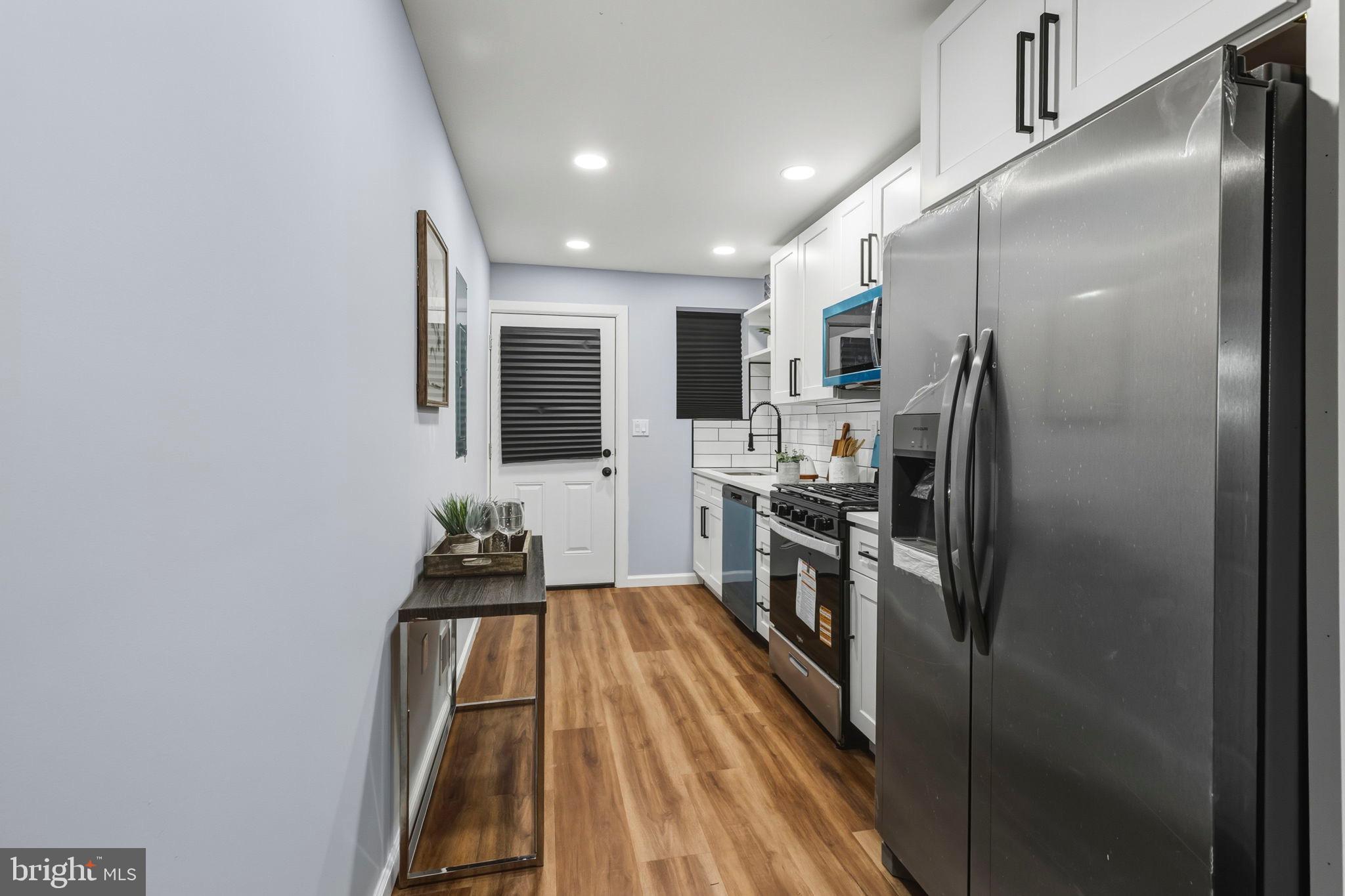 1618 North Regester Street Baltimore, MD 21213 - Photo 5 of 29 a kitchen with a refrigerator and a sink