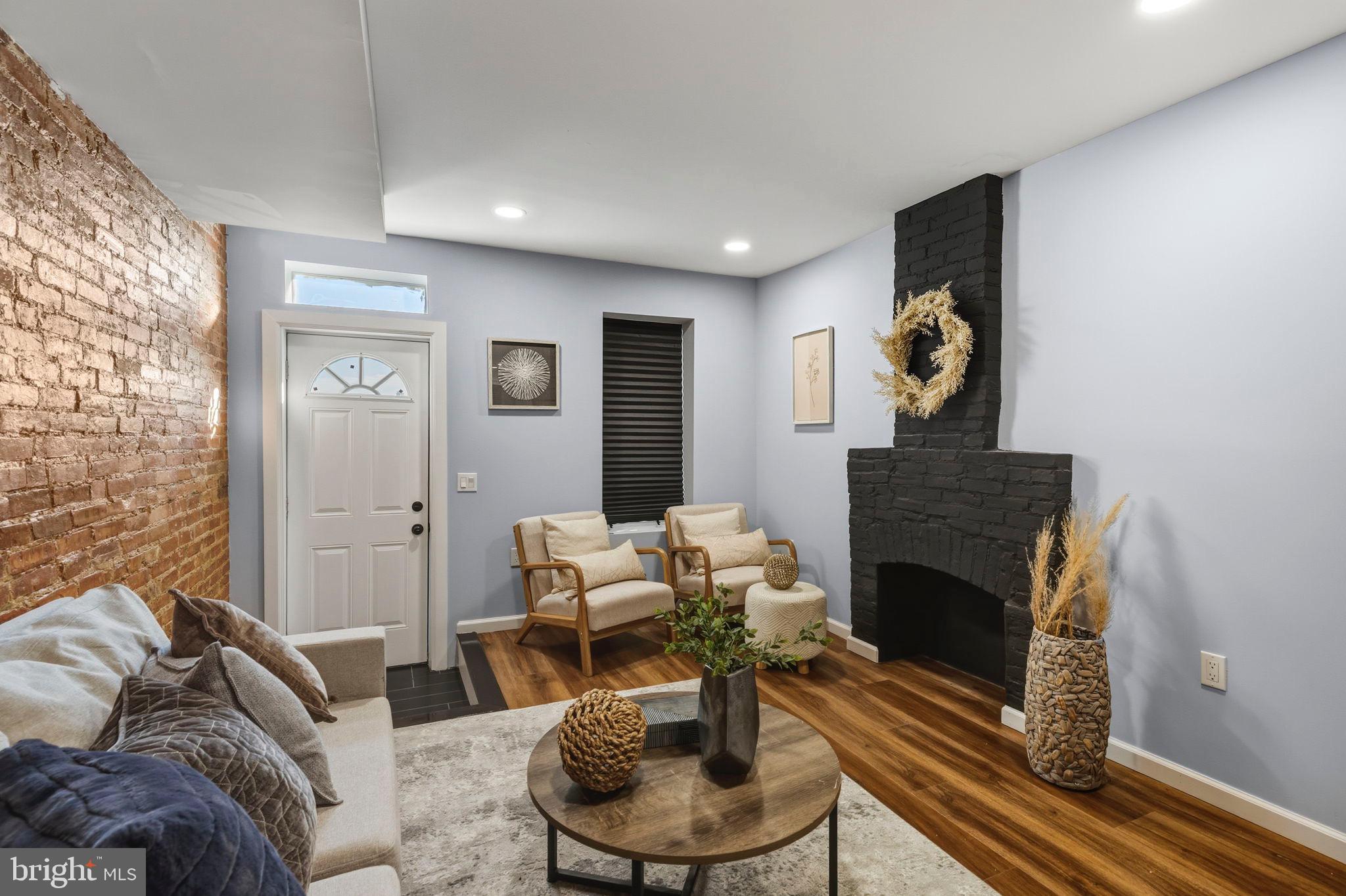 1618 North Regester Street Baltimore, MD 21213 - Photo 7 of 29 a living room with furniture and a fireplace