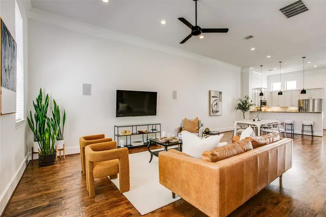 a living room with furniture wooden floor and a flat screen tv