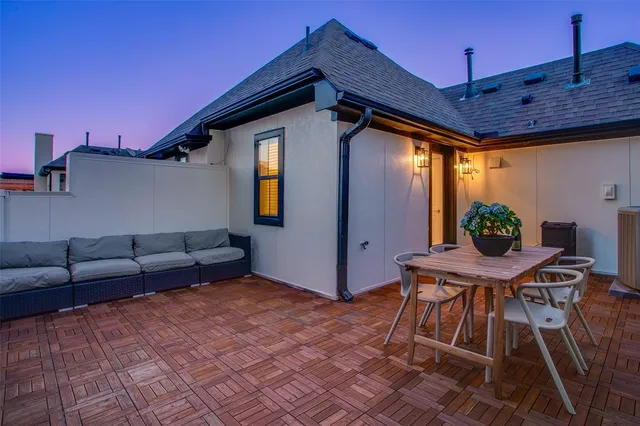 a backyard of a house with barbeque oven table and chairs