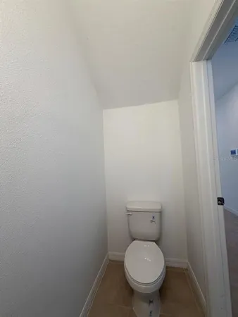 a white toilet sitting in a bathroom