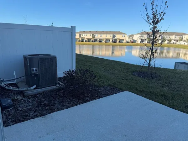a view of a house with a yard and a fountain