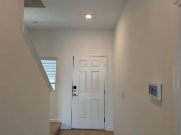 a view of hallway with closet and mirror
