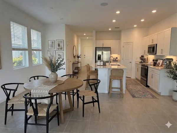 a kitchen with kitchen island granite countertop wooden floor and stainless steel appliances