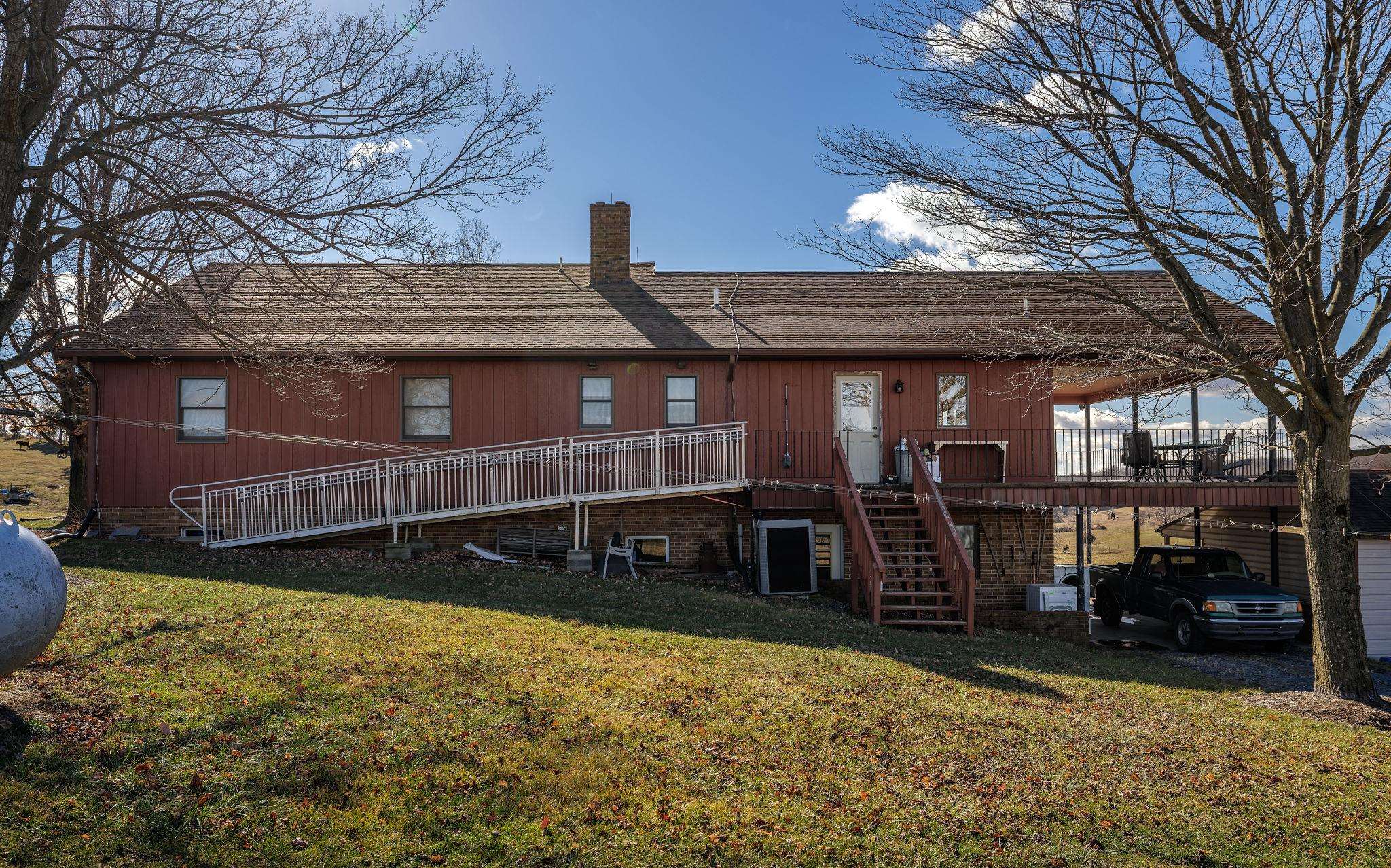 85-87 Curry Road Mount Solon, VA 22843 - Photo 13 of 59 a view of a house with a patio and a yard