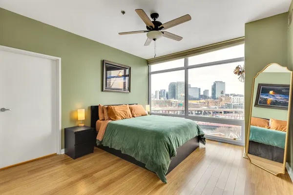 a bedroom with a large bed and a large window